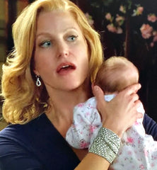 Breaking Bad's Skyler White holding Holly wearing 2 stacked Flinging Arrows Liquid Metal Bracelets